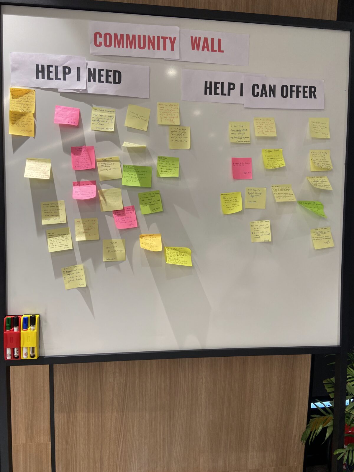 Two headers, titled "Help I Can Offer" and "Help I Need," were displayed on a whiteboard. Colored post-it notes were placed under each header.